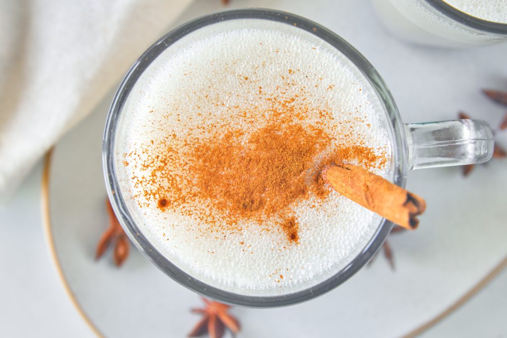 Starbucks copycat vegan chai latte with stick of cinnamon from above