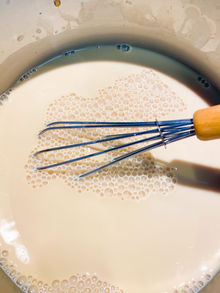 vegan chai latte being made in a pot on the stove