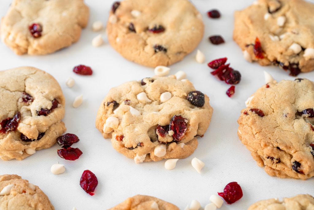 vegan cranberry cookies with white chocolate chips on baking tray