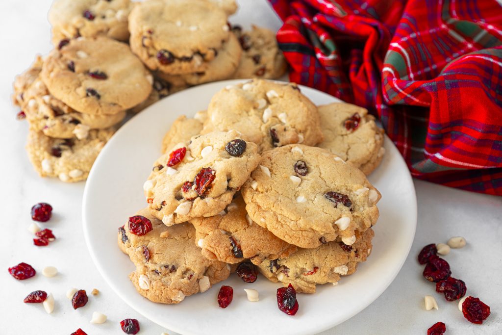 stacks of vegan cranberry cookies with white chocolate on serving dish