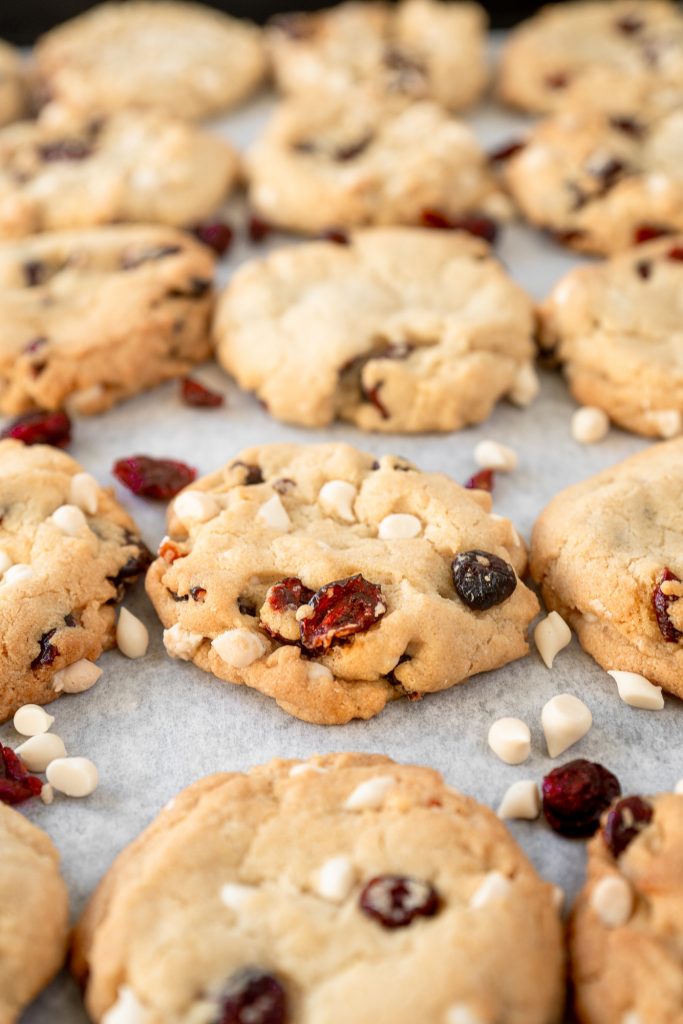 vegan cranberry cookies with white chocolate chips on baking sheet