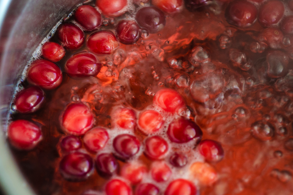 boiling fresh cranberries in a pot