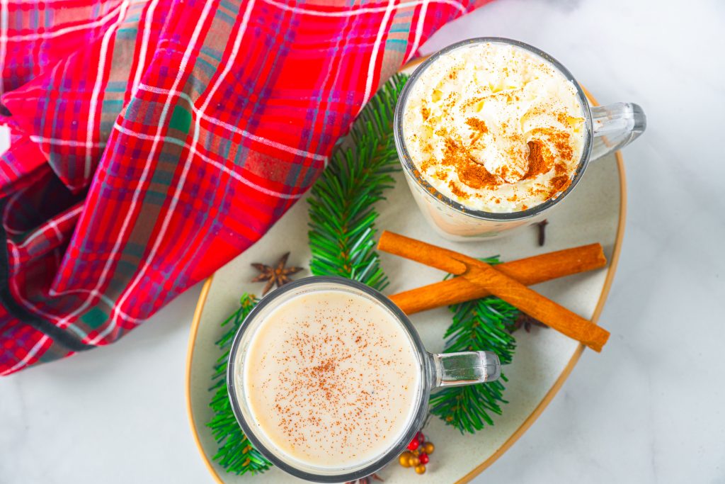 two cups of white color eggless eggnog from above on serving tray
