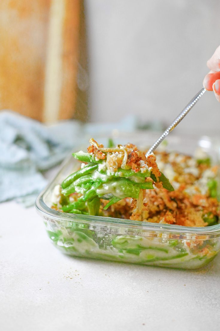 vegan green bean casserole being scooped up with spoon