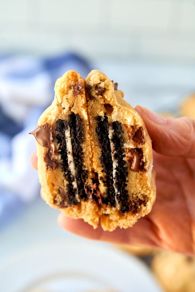 hand holding an oreo stuffed cookie cut in half