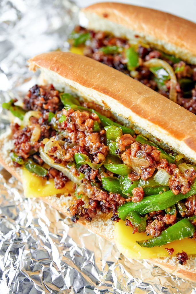 two vegan cheesesteaks on tin foil