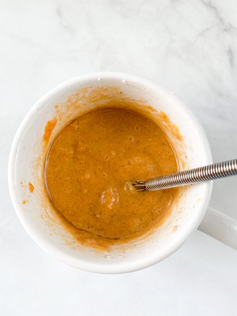 batter for a pumpkin spice mug cake in a mug