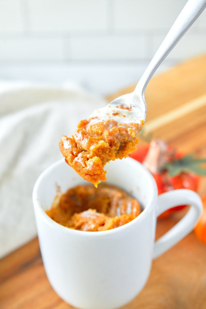 scooping out a piece of pumpkin mug cake