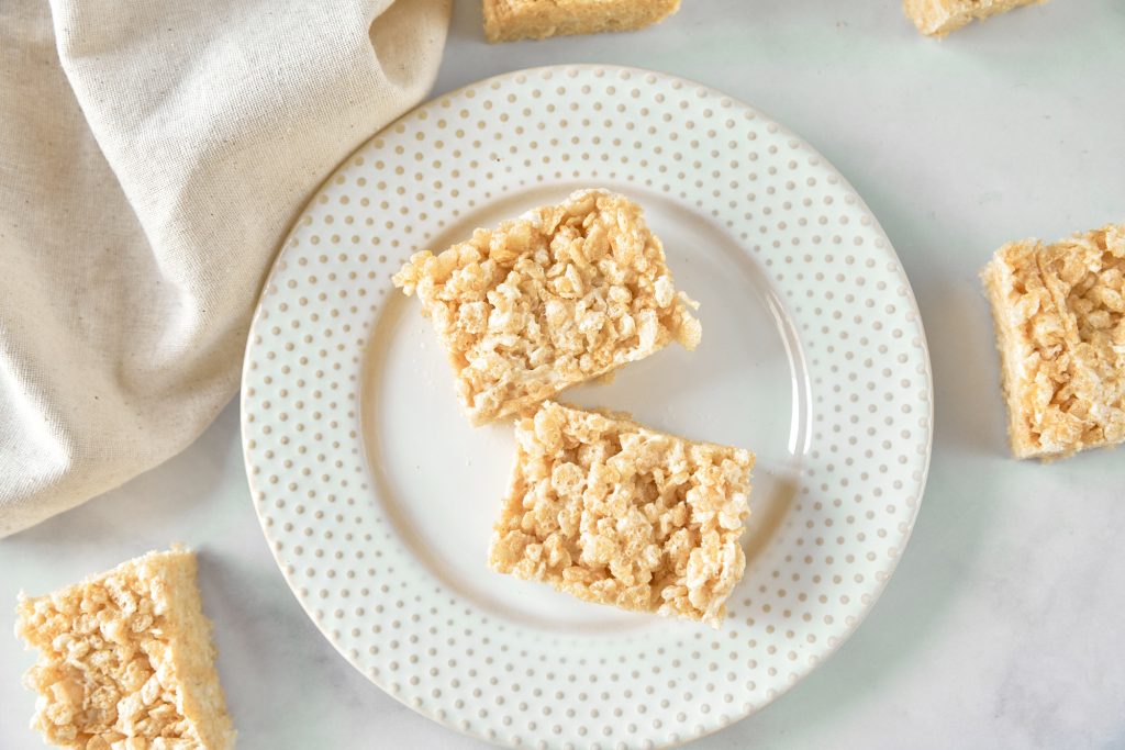 above photo of multiple vegan rice krispie treats on plate and counter