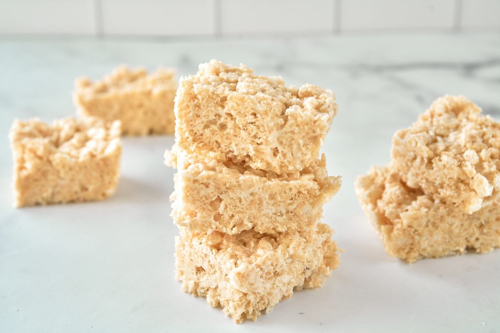 vegan rice krispie treats stacked on a white counter top