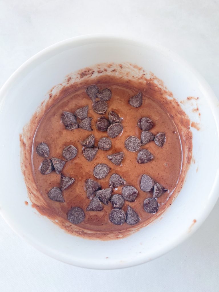 vegan mug cake with chocolate chips before cooking in the microwave
