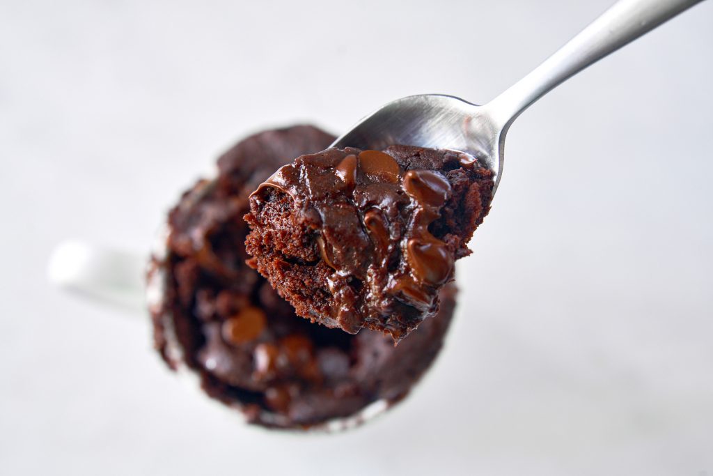 close up of a scoop of molten chocolate vegan mug cake on a spoon