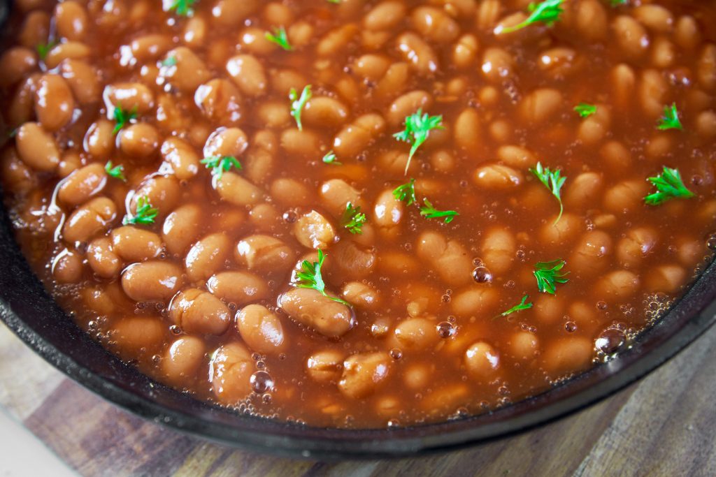 close up of homemade vegetarian baked beans in cast iron dish