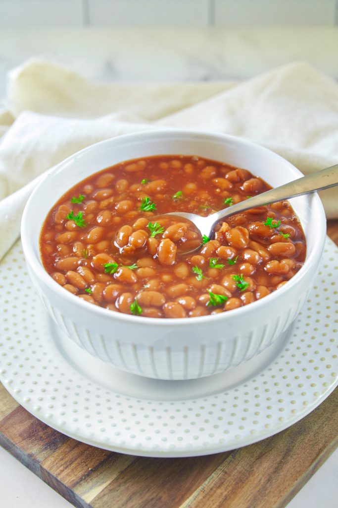 vegan baked beans recipe in a serving bowl with a spoon