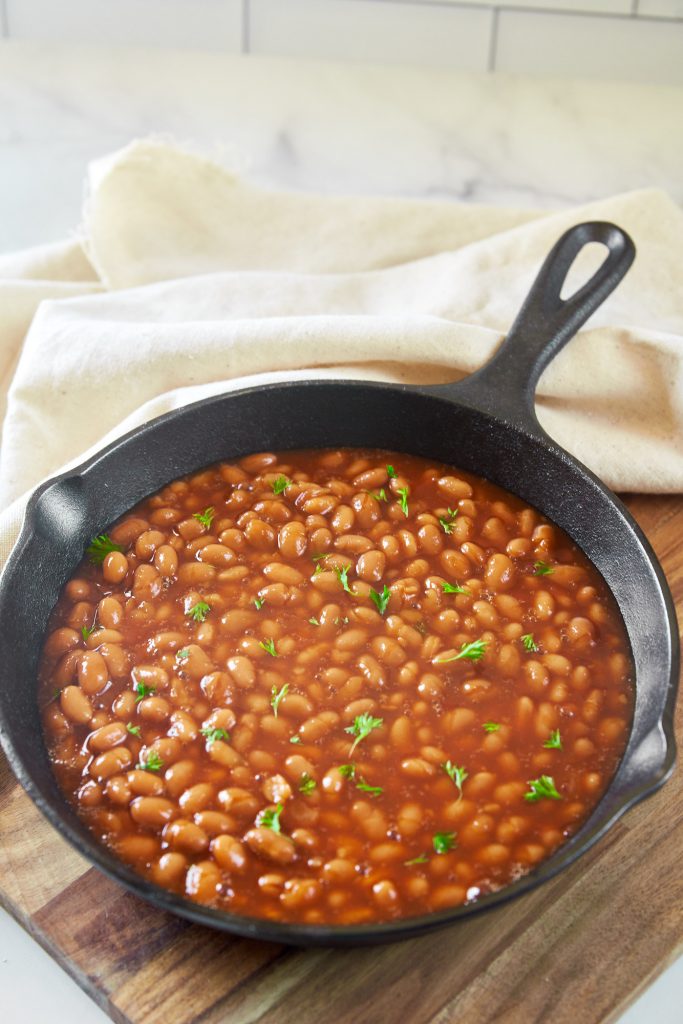 vegan baked beans recipe being made in a cast iron skillet