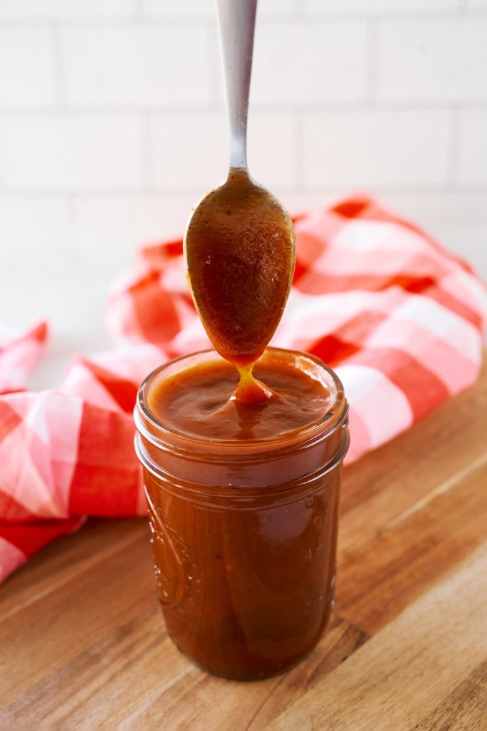 spoon scooping up vegan barbecue sauce