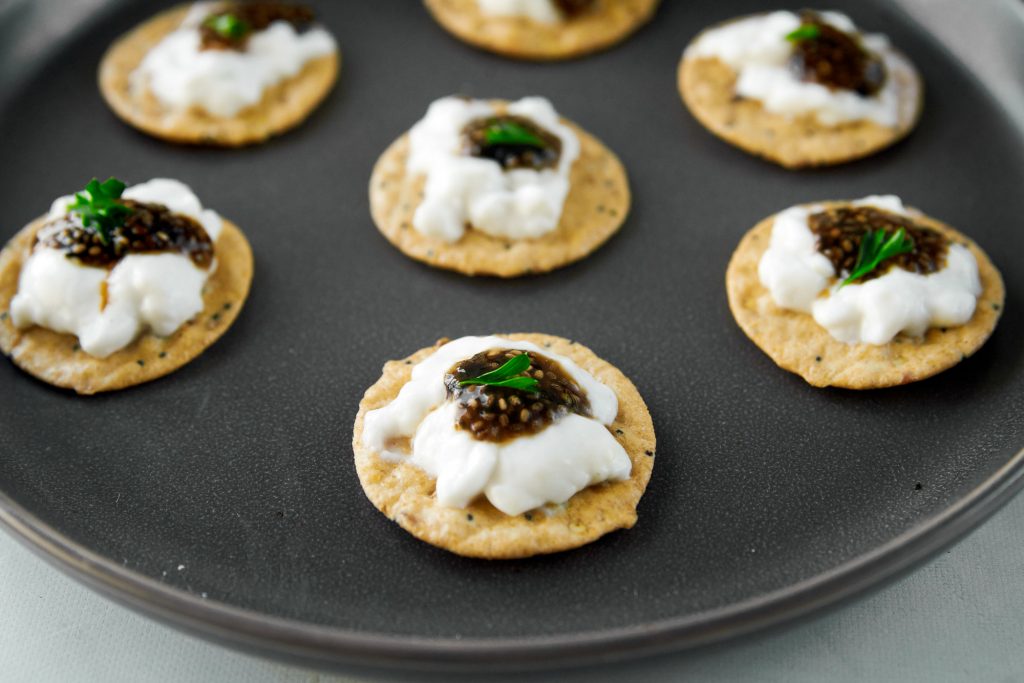 vegan caviar being served on crackers