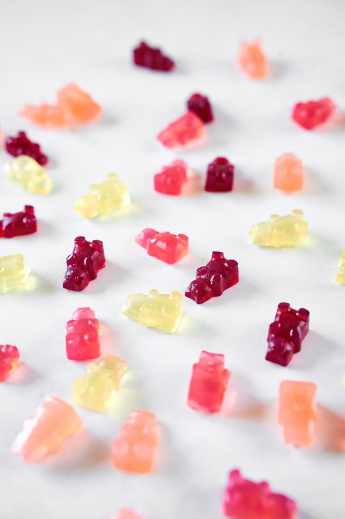 vegan gummy fruit snacks in varying colors laying on a counter