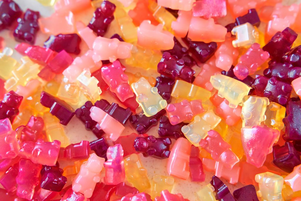 bunch of agar agar gummies on a plate in varying colors