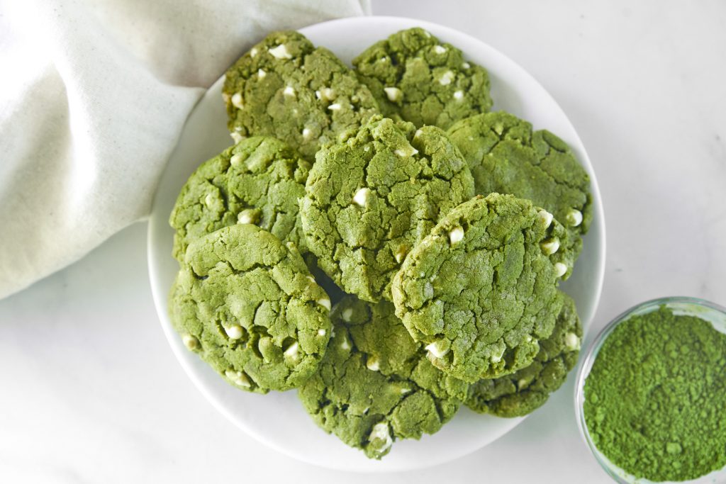 tray of vegan matcha cookies with a bowl of matcha green tea powder
