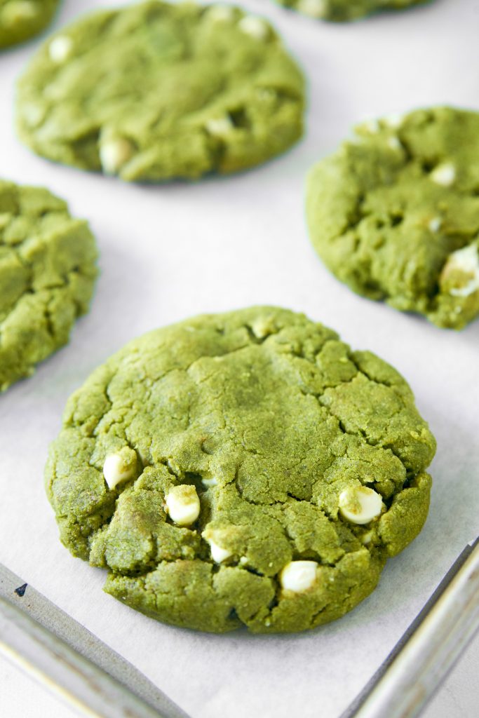 close up of matcha white chocolate cookies on cooling rack
