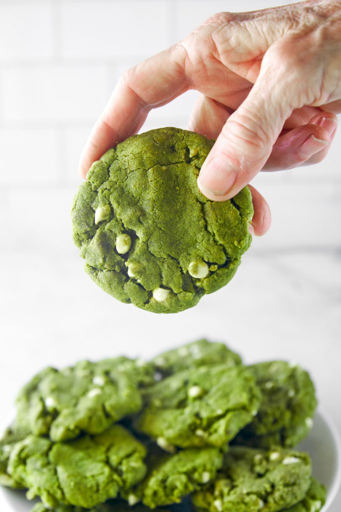 hand holding a green tea cookie with matcha