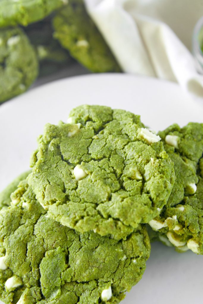 close up of matcha white chocolate cookies on serving plate