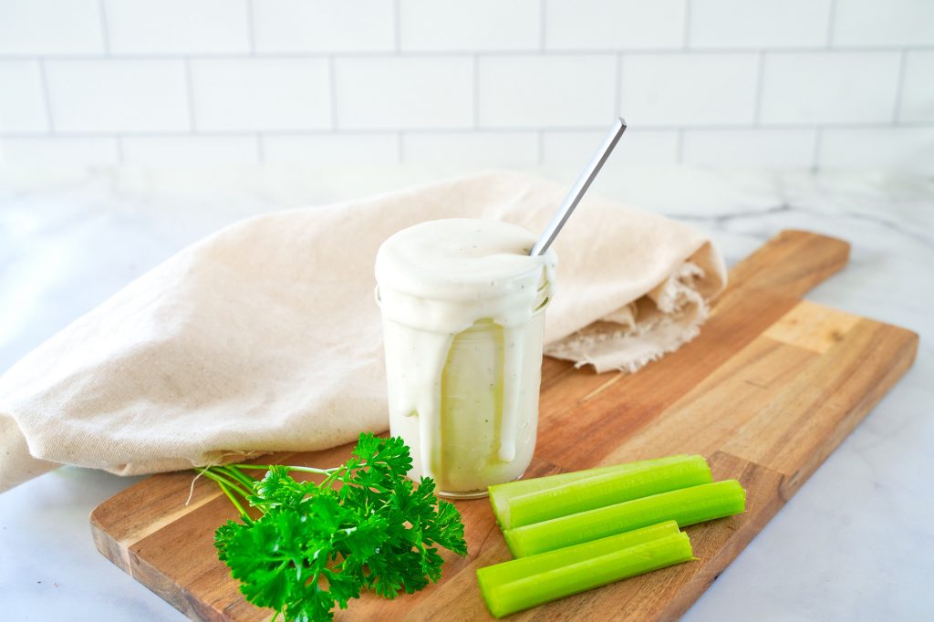 homemade vegan ranch dressing recipe in a storage jar spilling over the side