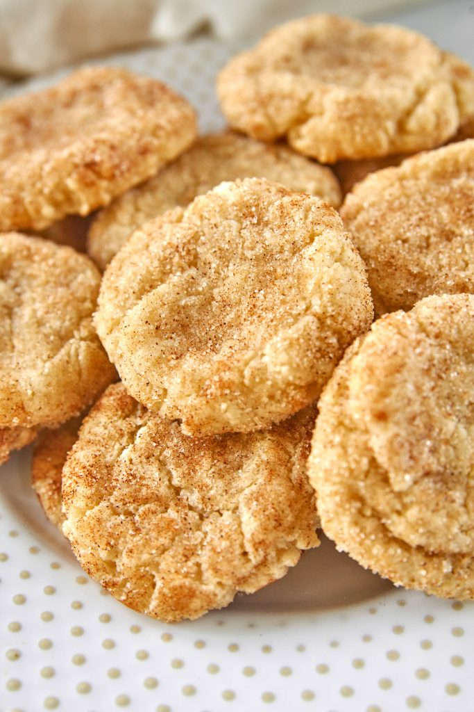 close up of vegan snickerdoodles cookies on a plate with cinnamon sugar dusting