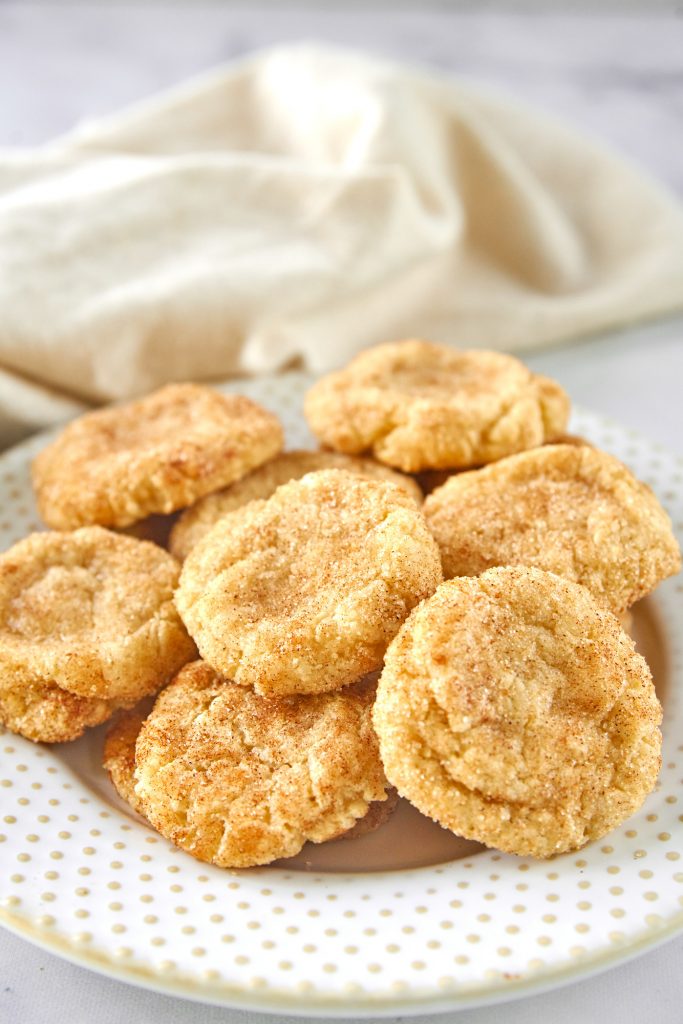 easy vegan snickerdoodles on a plate with a dish towel