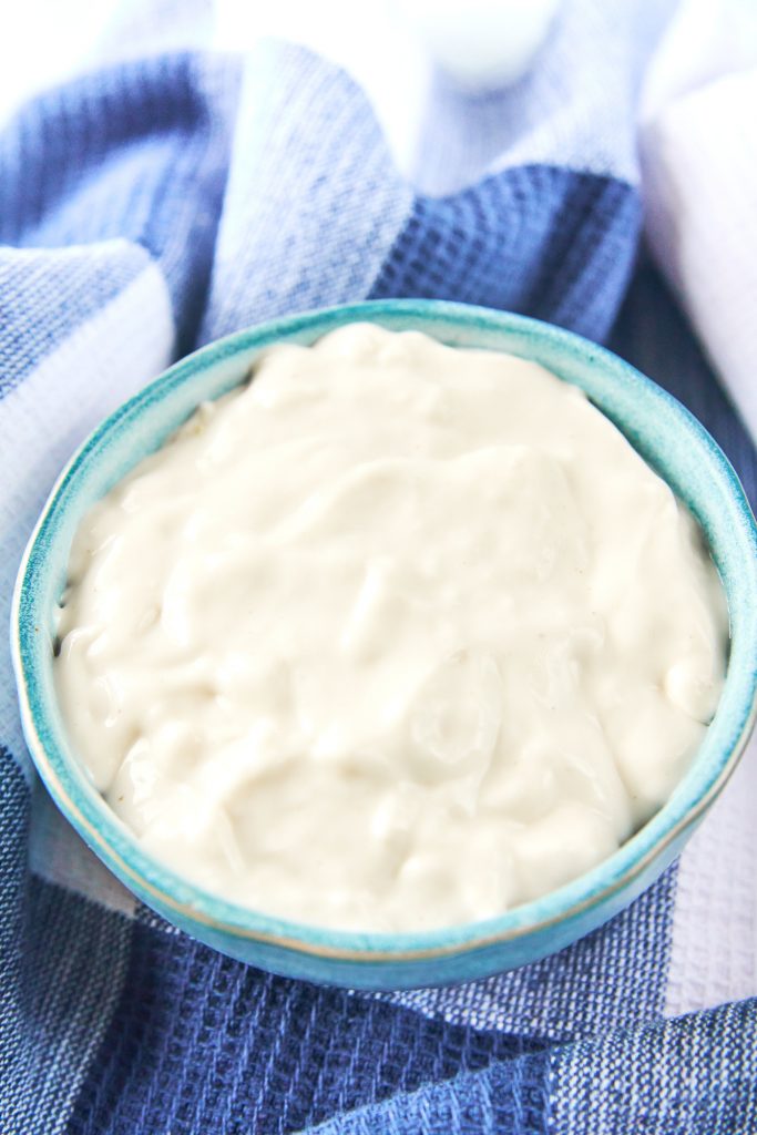 dairy free sour cream in a bowl on top of a dish towel