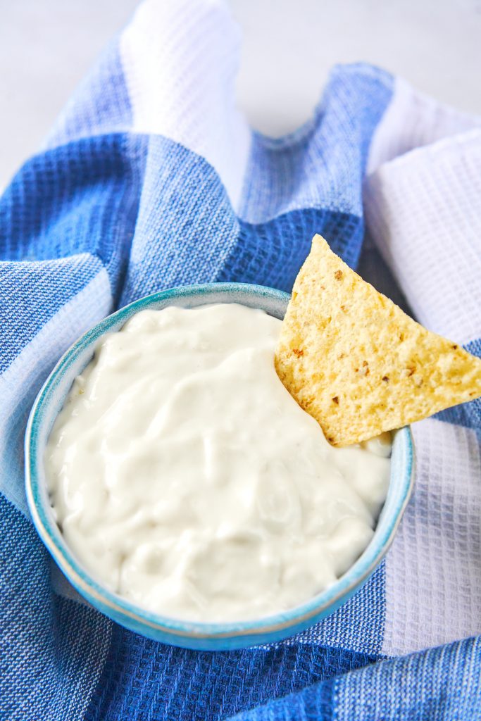 chip on the side of a bowl of easy vegan sour cream
