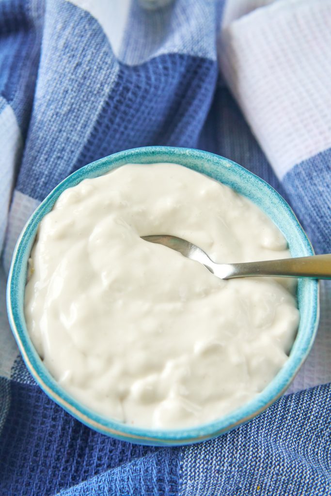 spoon scooping out a little bit of cashew sour cream with no dairy