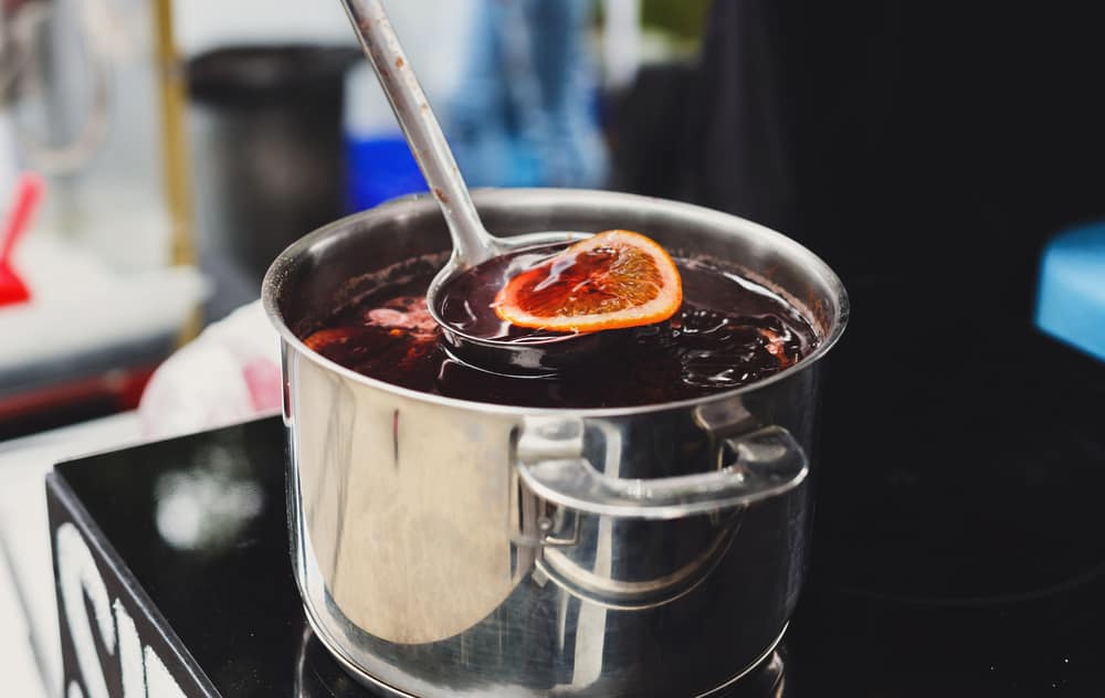 making mulled wine in a large pot
