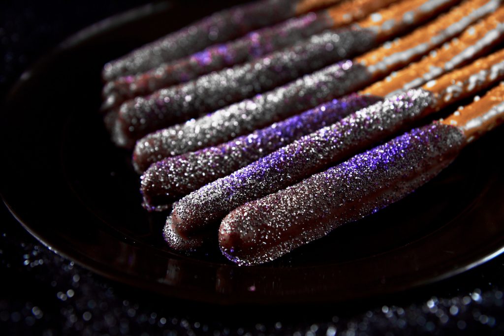 Hocus pocus halloween pretzels close up with purple icing sugar