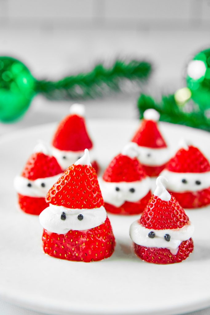 close up on santa strawberries with green in the background