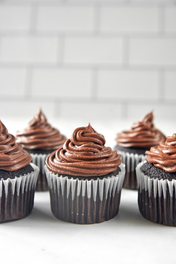 lots of vegan chocolate cupcakes with chocolate icing