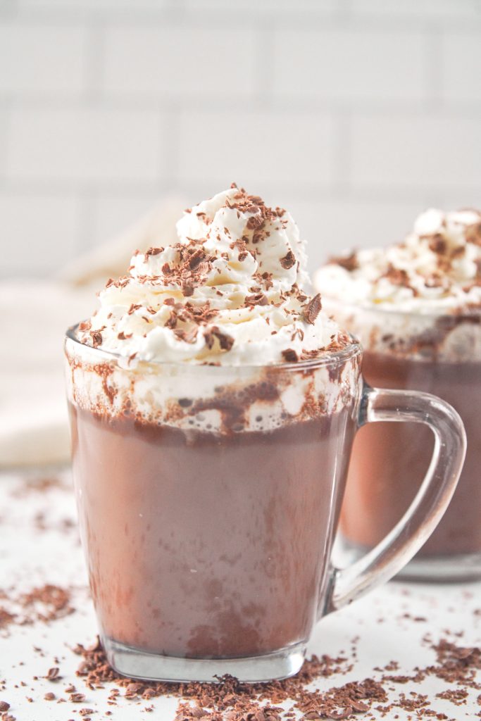 two mugs of vegan hot chocolate with chocolate shavings