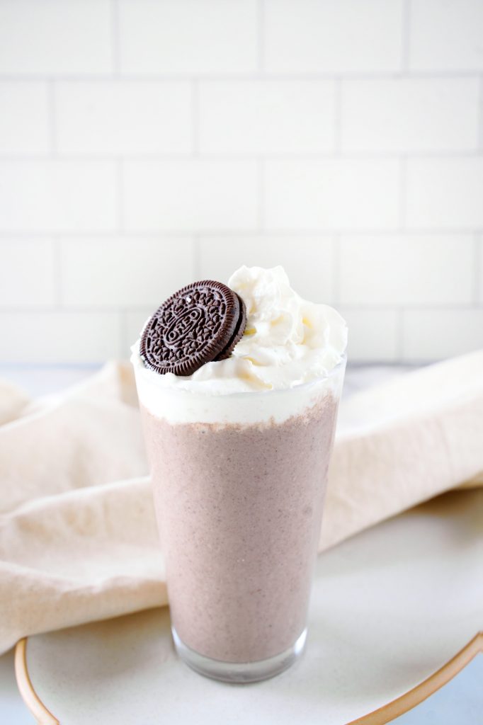 vegan milkshake topped with oreo cookie and whipped cream