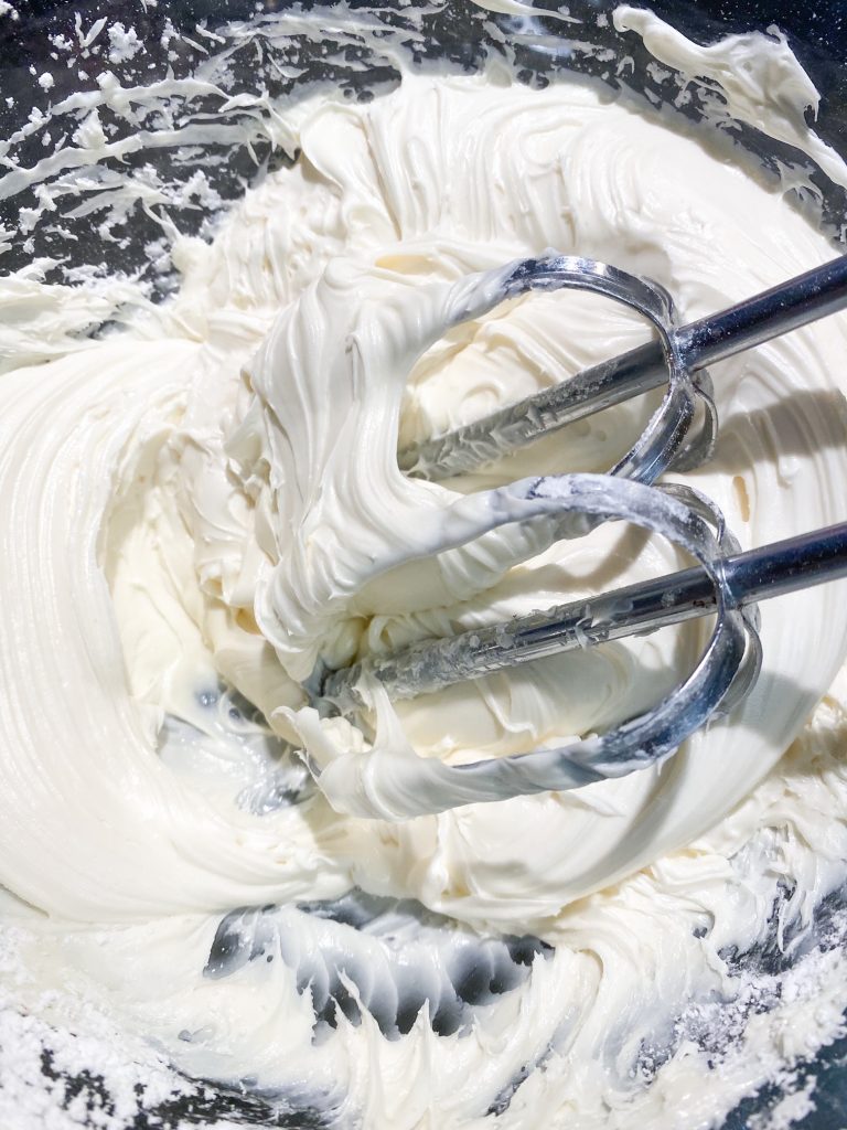 beating vegan vanilla frosting in bowl