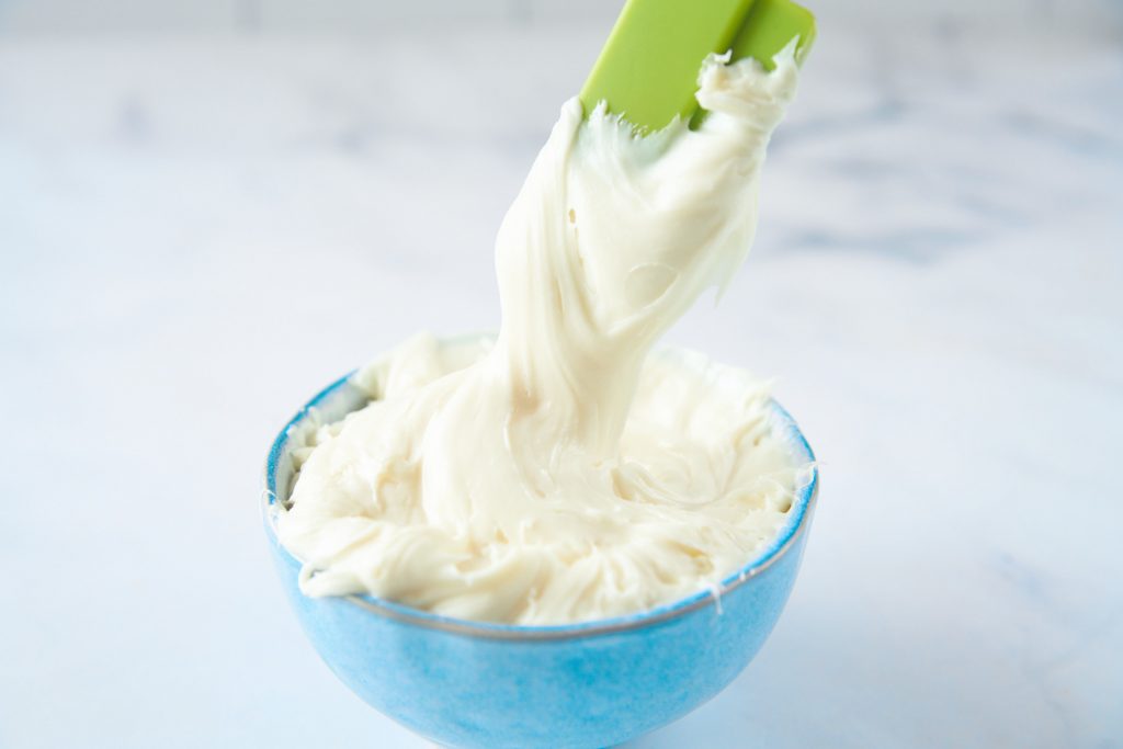 spatula scooping up vegan vanilla frosting