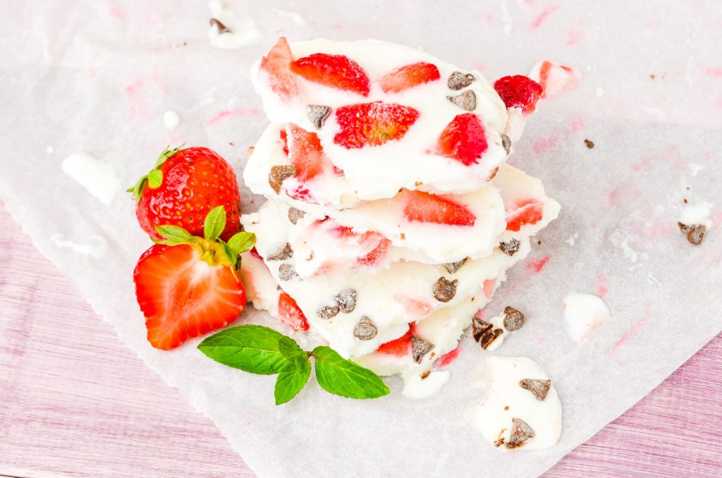 close up of frozen yogurt bark with strawberries and chips