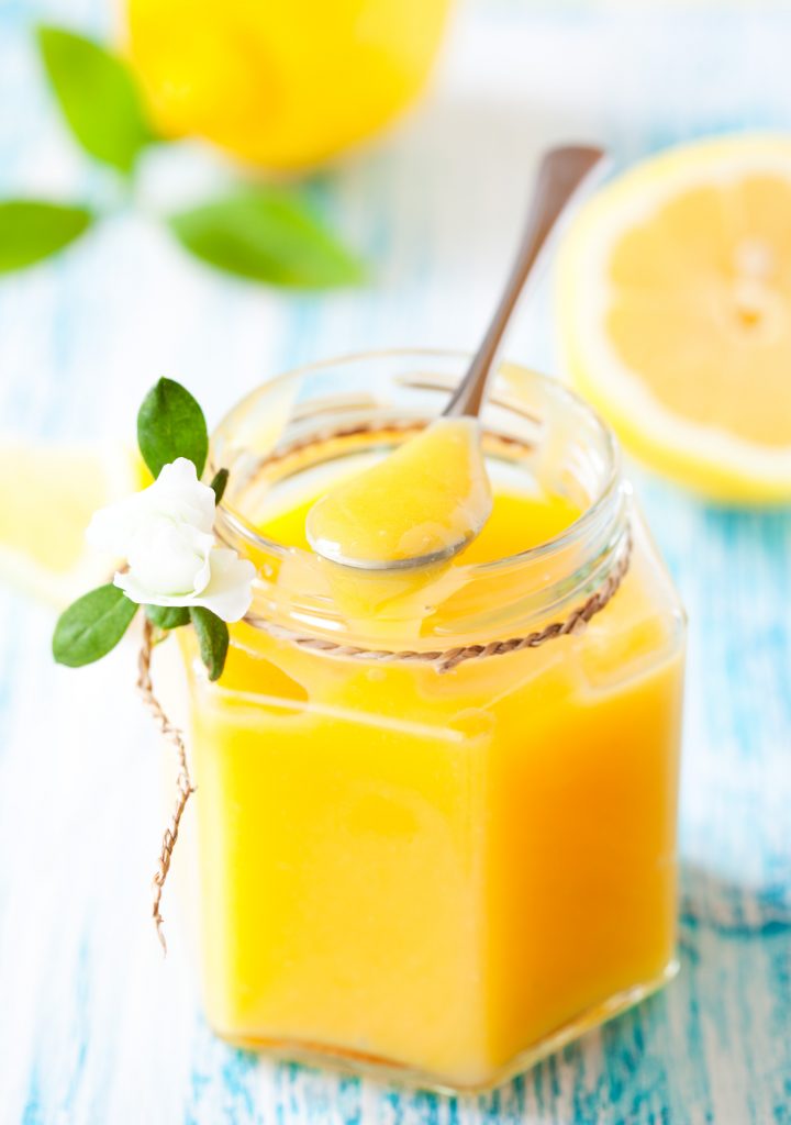 scooping out vegan lemon curd from a jar