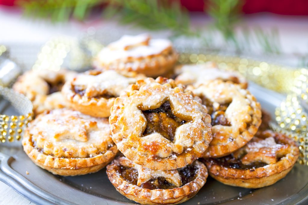 vegan mince pies on a plate with powdered sugar