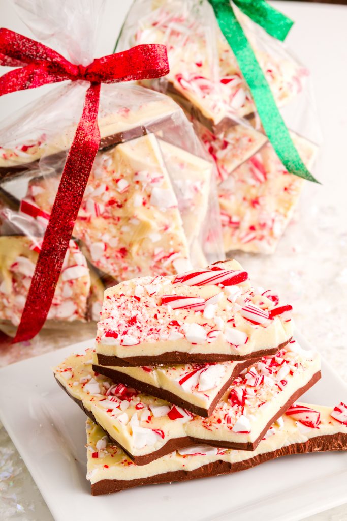 vegan peppermint bark in cellophane for gift giving with red and green ribbons