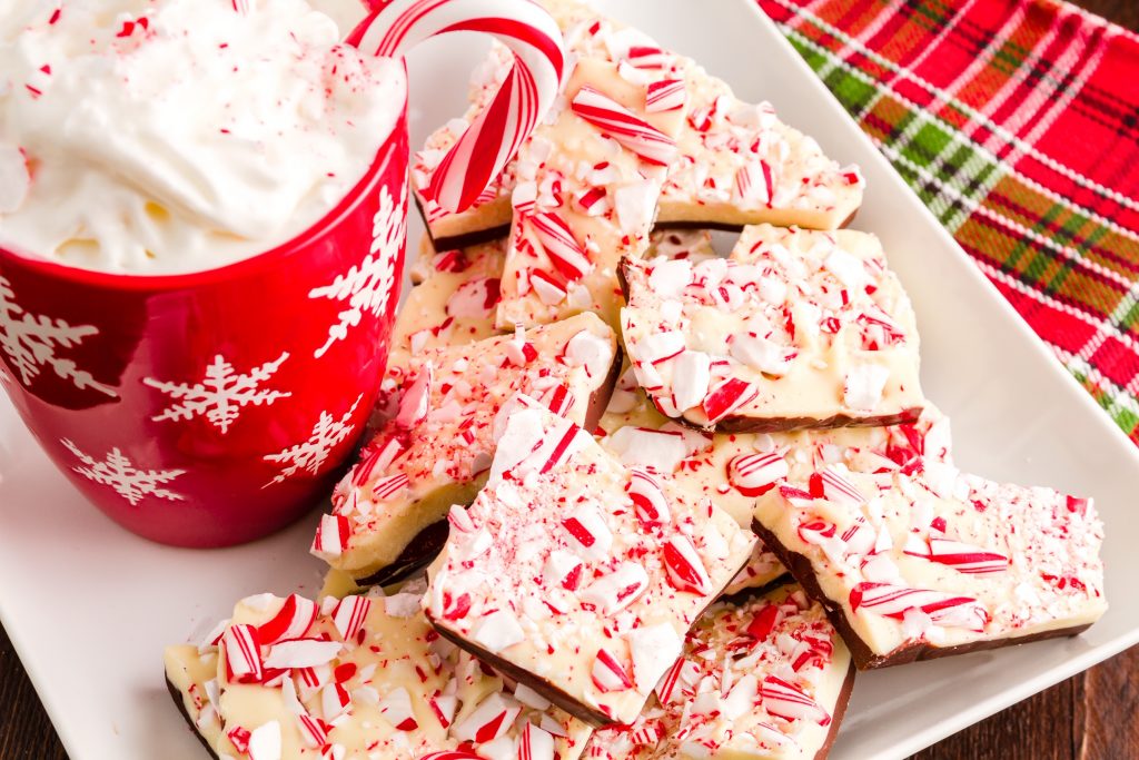 vegan peppermint bark on a plate with a red mug