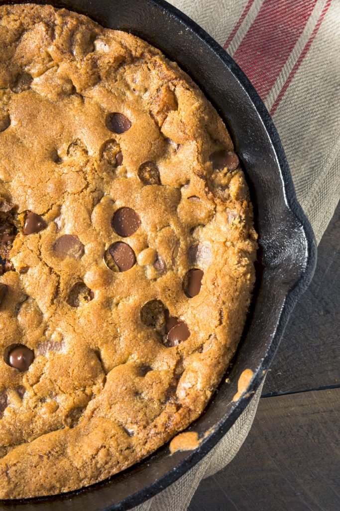 side of a vegan chocolate chip cookie cake made in a cast iron pan