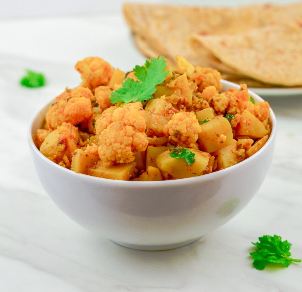 Photo of Aloo Gobi being served in a white round bowl.