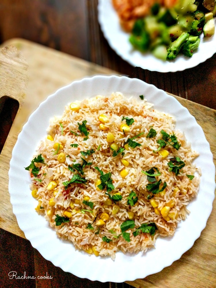 Photo of Spicy Mexican Rice being served on a scalloped round white plate.