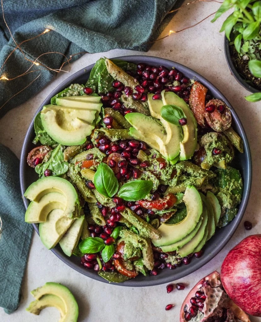 Photo of Vegan Pesto Pasta Salad being served in a round gray bowl. It is one of the prettiest sides for Stuffed Peppers.